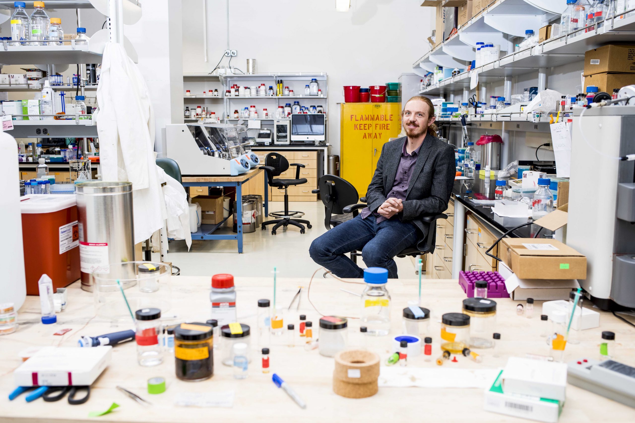 Man sits on chair in lab