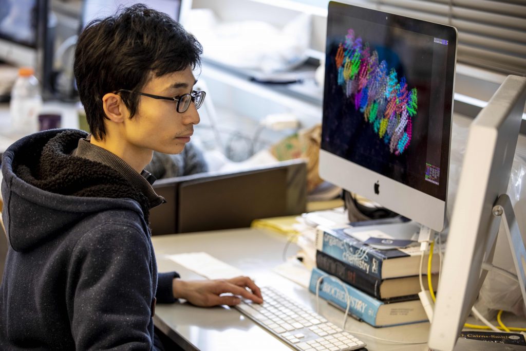 student sits in front of computer