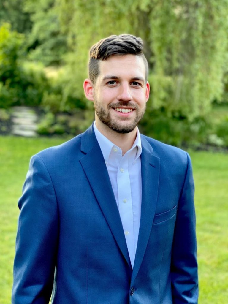 Nick in a blue suit outside.