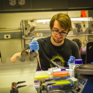 Ty Jorgenson in the lab pipetting