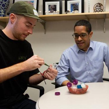 two men sitting at table looking at hydrogels