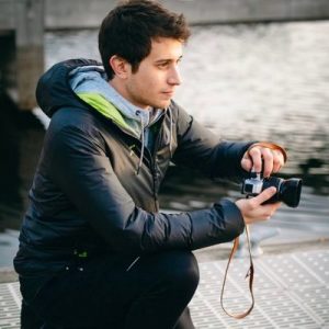 man holds camera