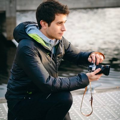 man holds camera