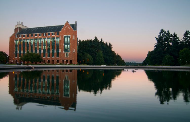 A picture of a brick building and a fountain on a university campus