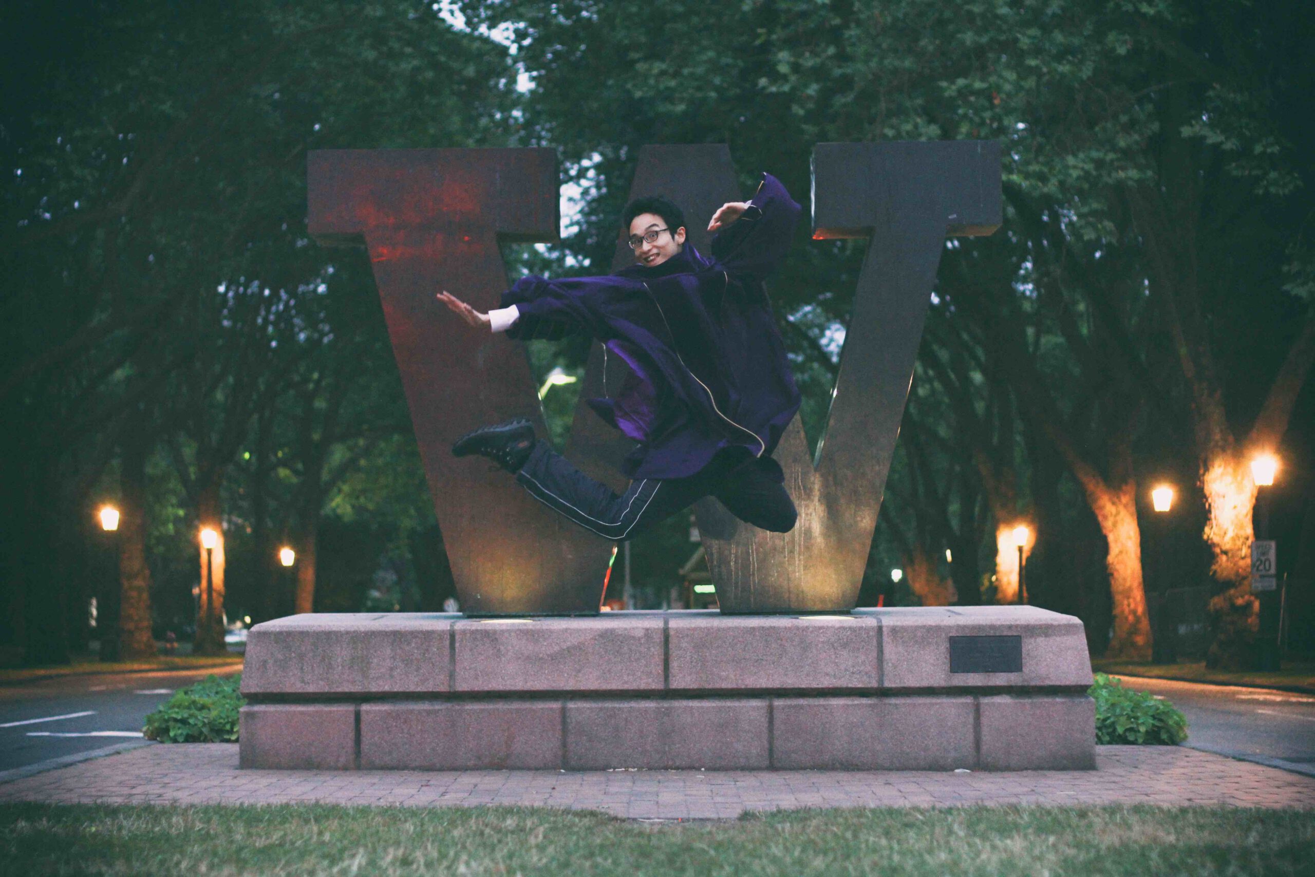 Student jumping in graduation regalia