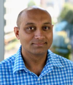Sid Venkatesh from the shoulders up, in a blue checkered shirt